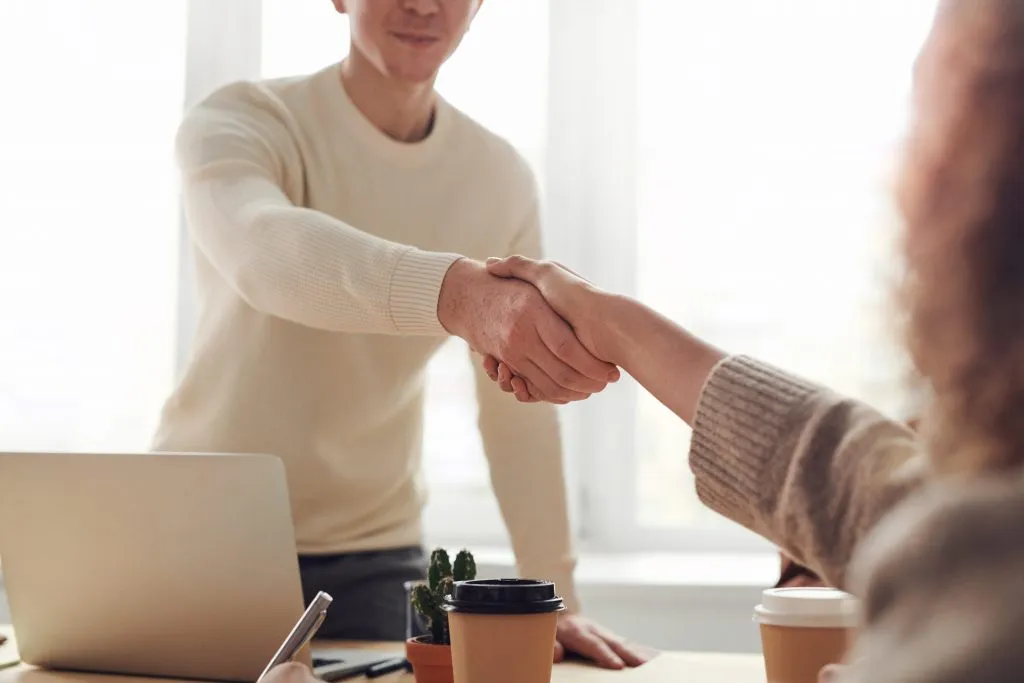 Photo of a man and a woman shaking hands