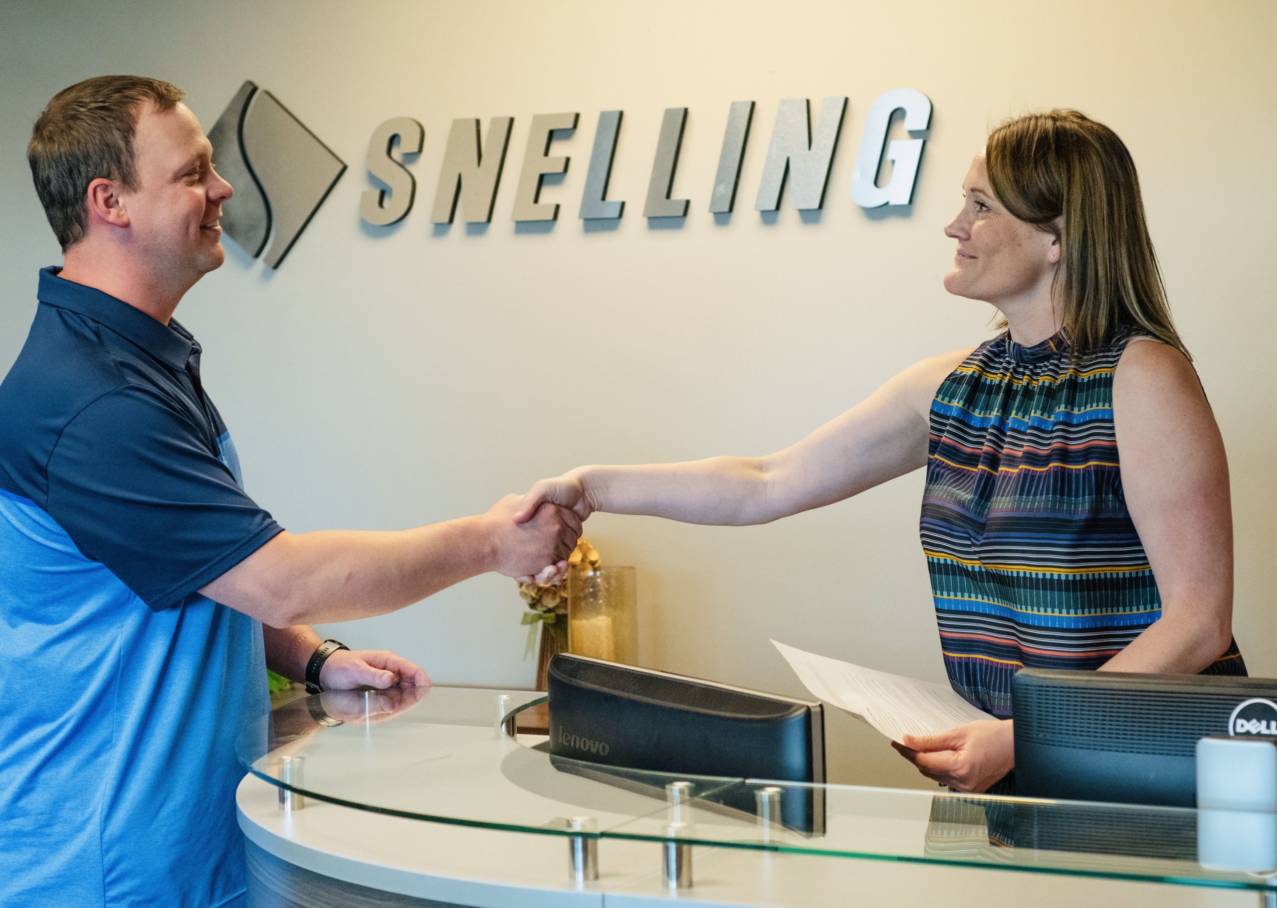 Photo of Snelling Staffing of Northern Colorado Office, where a recruiter, Sheri Reighard, happily shakes hands with a prospective employee.