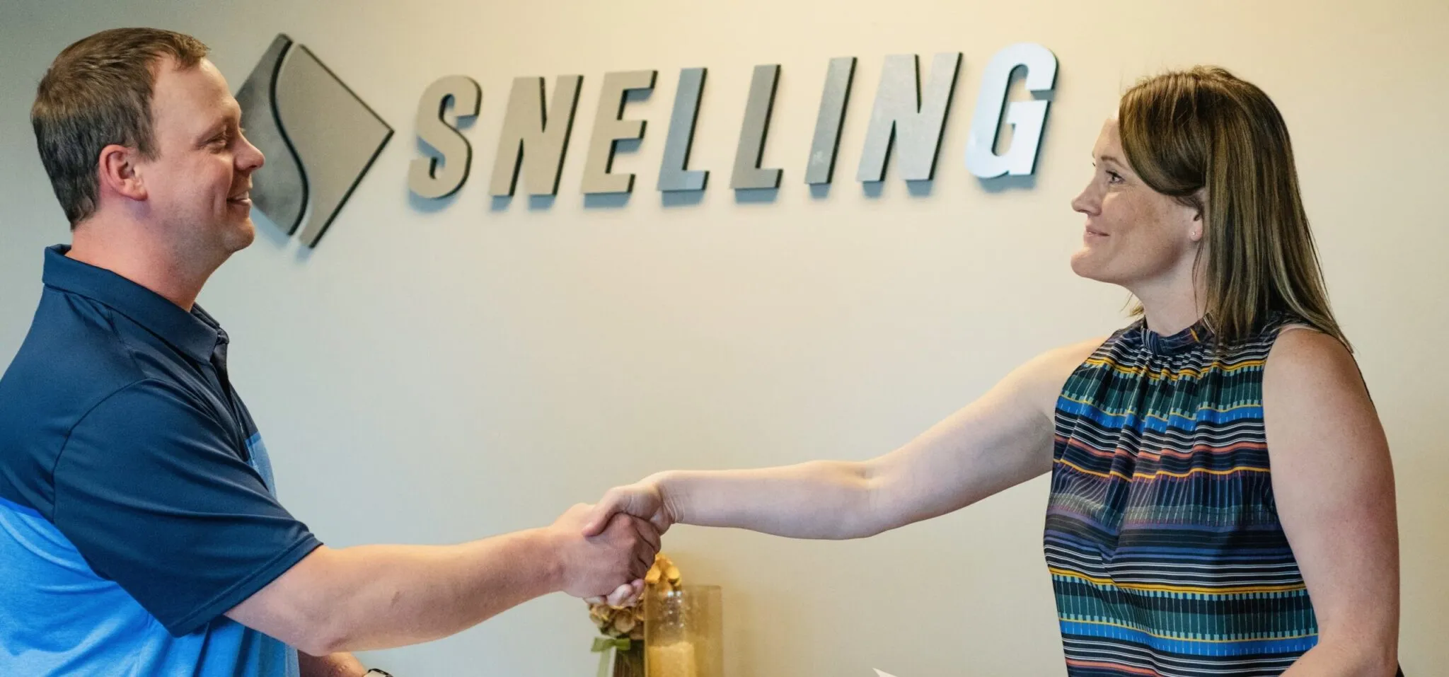Photo of Snelling Staffing of Northern Colorado Office, where a recruiter, Sheri Reighard, shakes hands with a prospective employee.